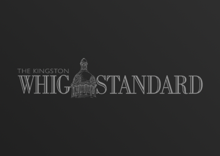 The Kingston Whig Standard logo on dark gradient background